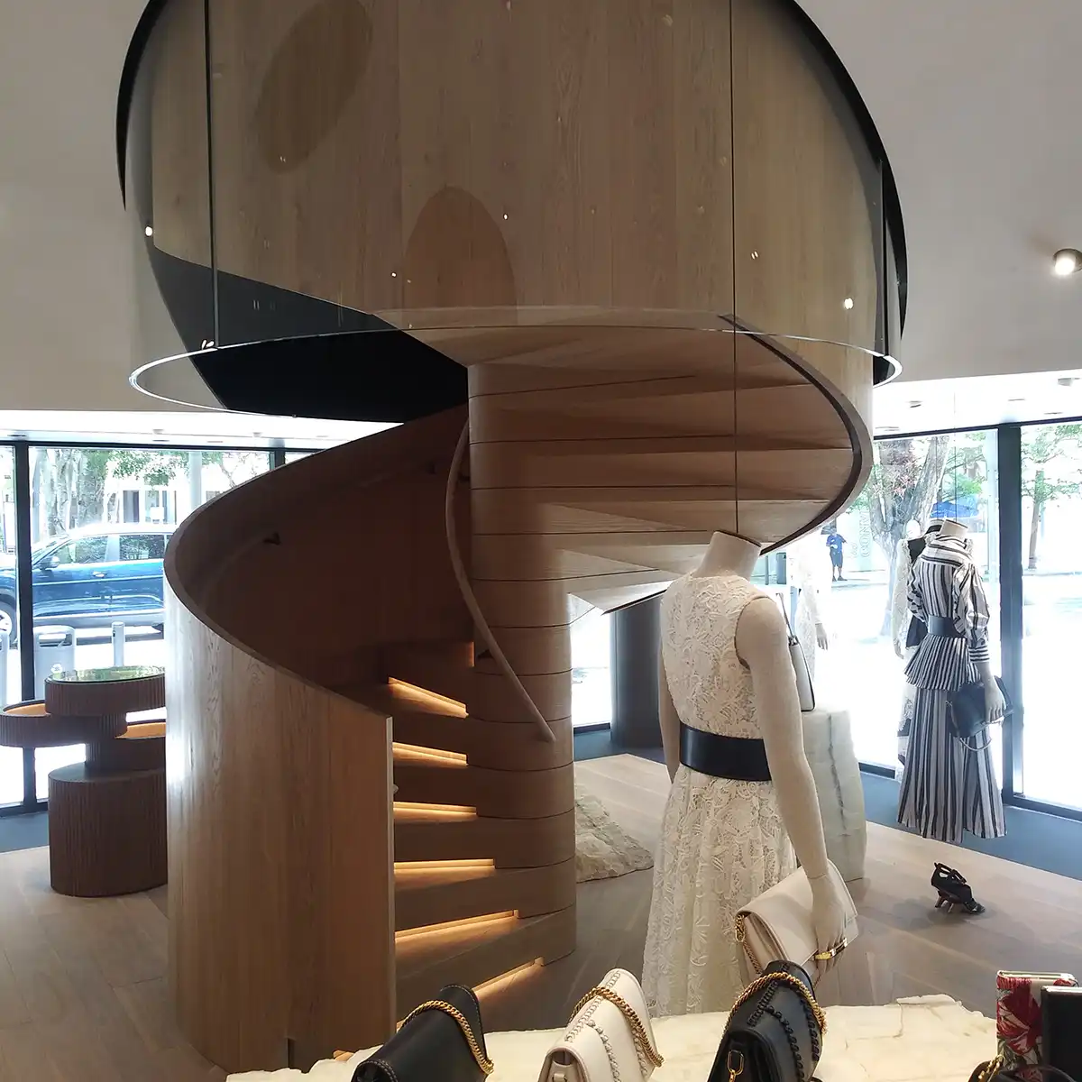 Custom wood spiral staircase in a boutique retail interior