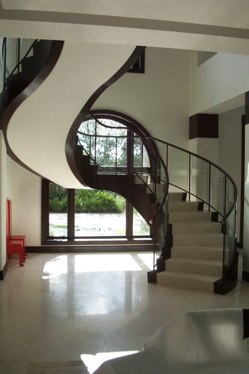 Curved staircase with wood handrail