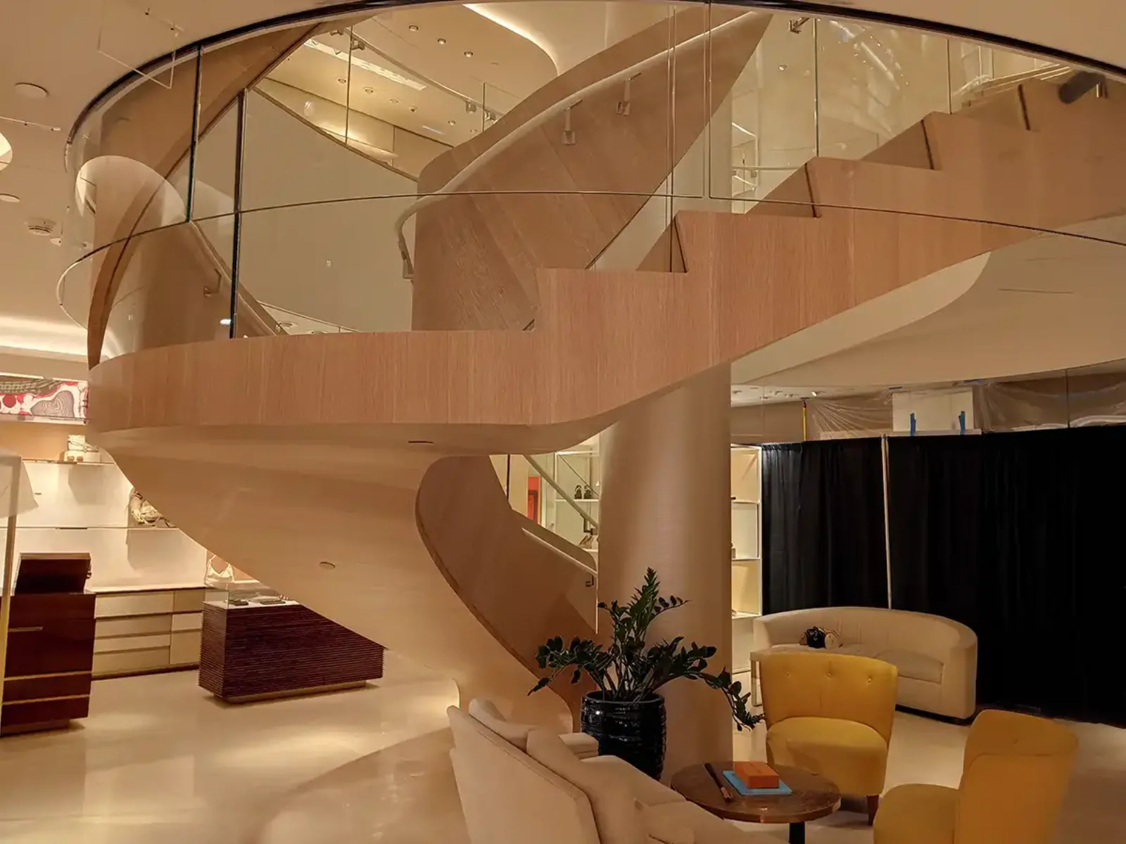 Sculptural helical wood-and-glass staircase